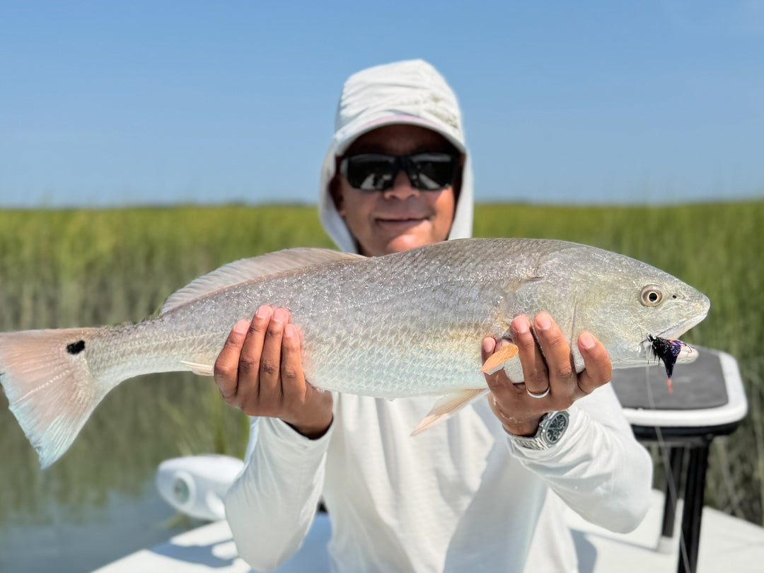 A person holding a red drum