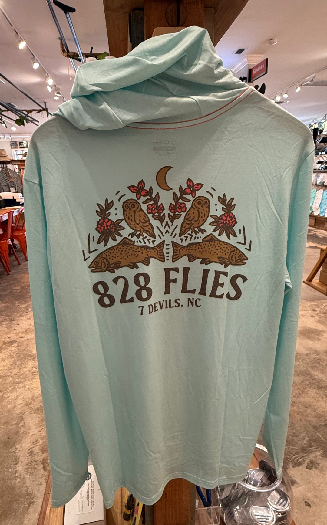 Back view of light mint green technical fishing hoody with owl and fish graphic