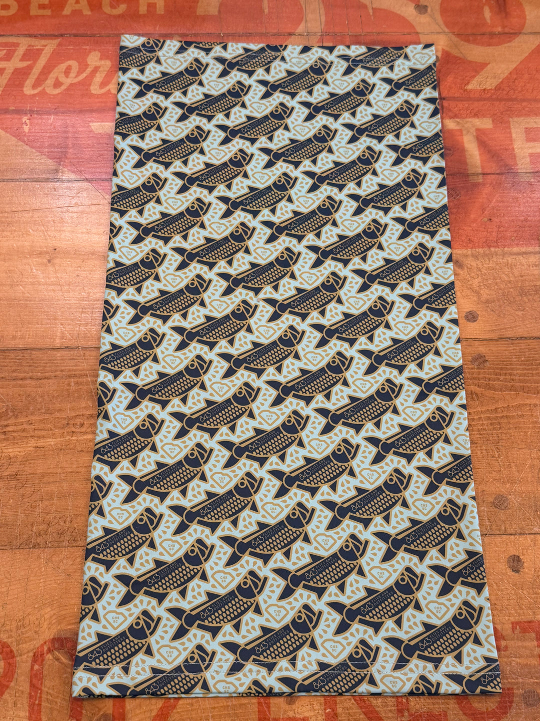 Light blue sun mask with navy fish and gold diamond pattern