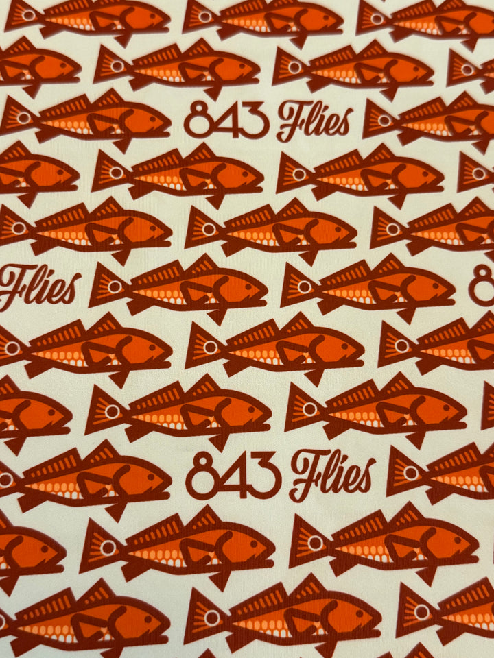 Close-up of cream polyester weave showing orange fish print on sun gaitor