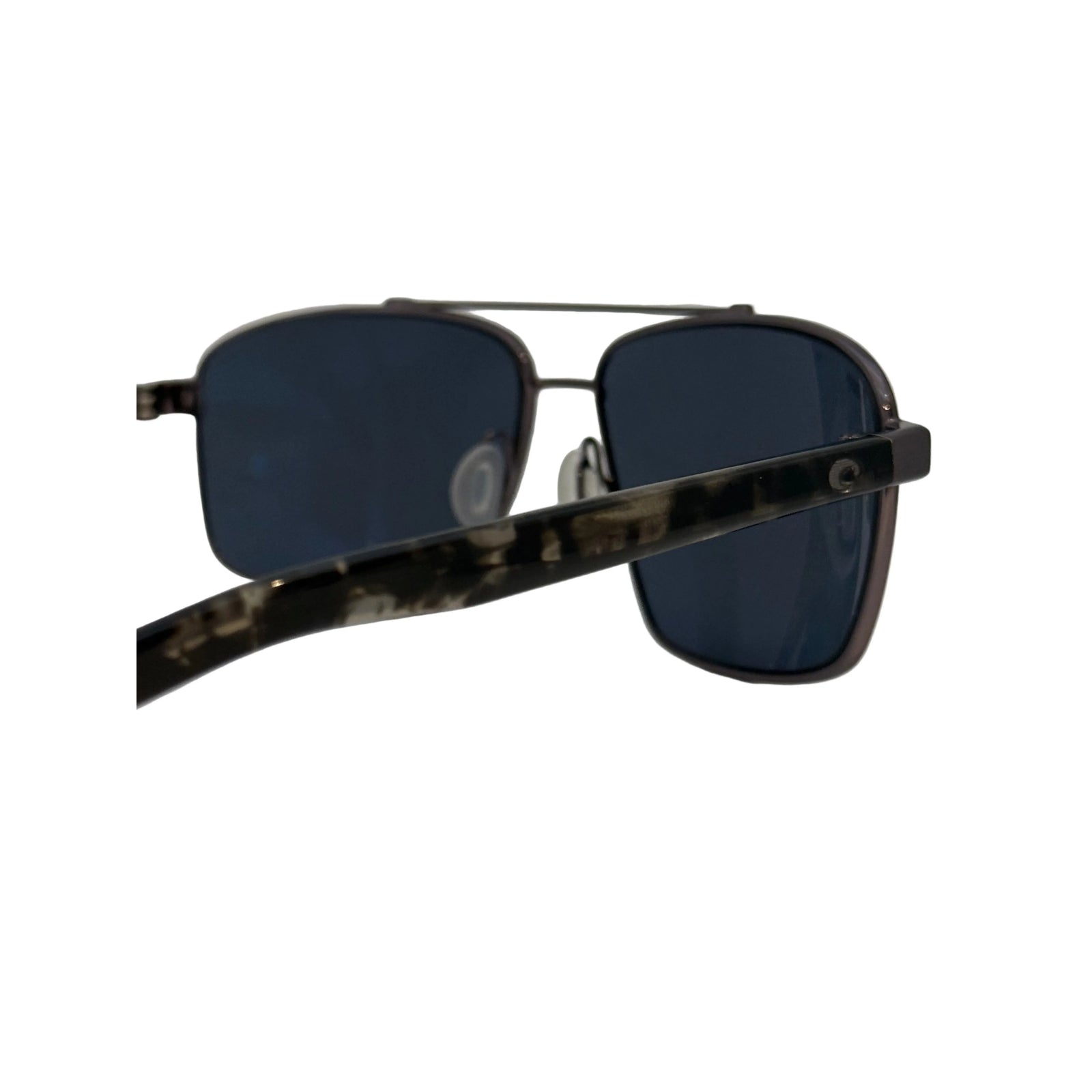 Close-up of Costa Flagler sunglasses showing camo temple pattern and C logo hinge detail