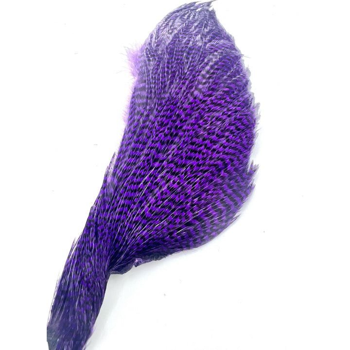 Vibrant violet-purple dyed half cape feather with dark transverse barring