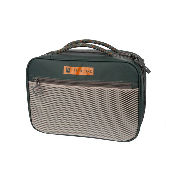 Front view of Fishpond Backwater fly tying bag featuring beige mesh pocket and orange logo patch