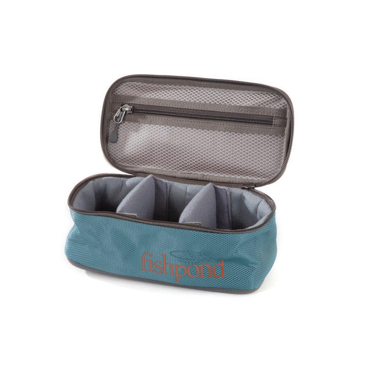 Empty Fishpond Ripple Reel Case interior with padded dividers and mesh zippered pocket