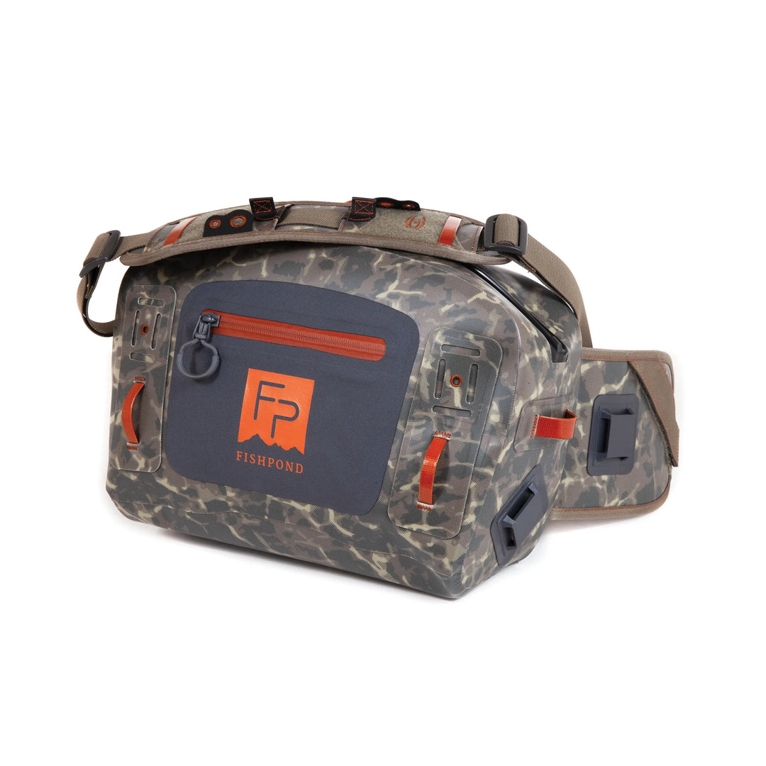 Fishpond Thunderhead Submersible Lumbar hip pack in grey camo with orange zippers