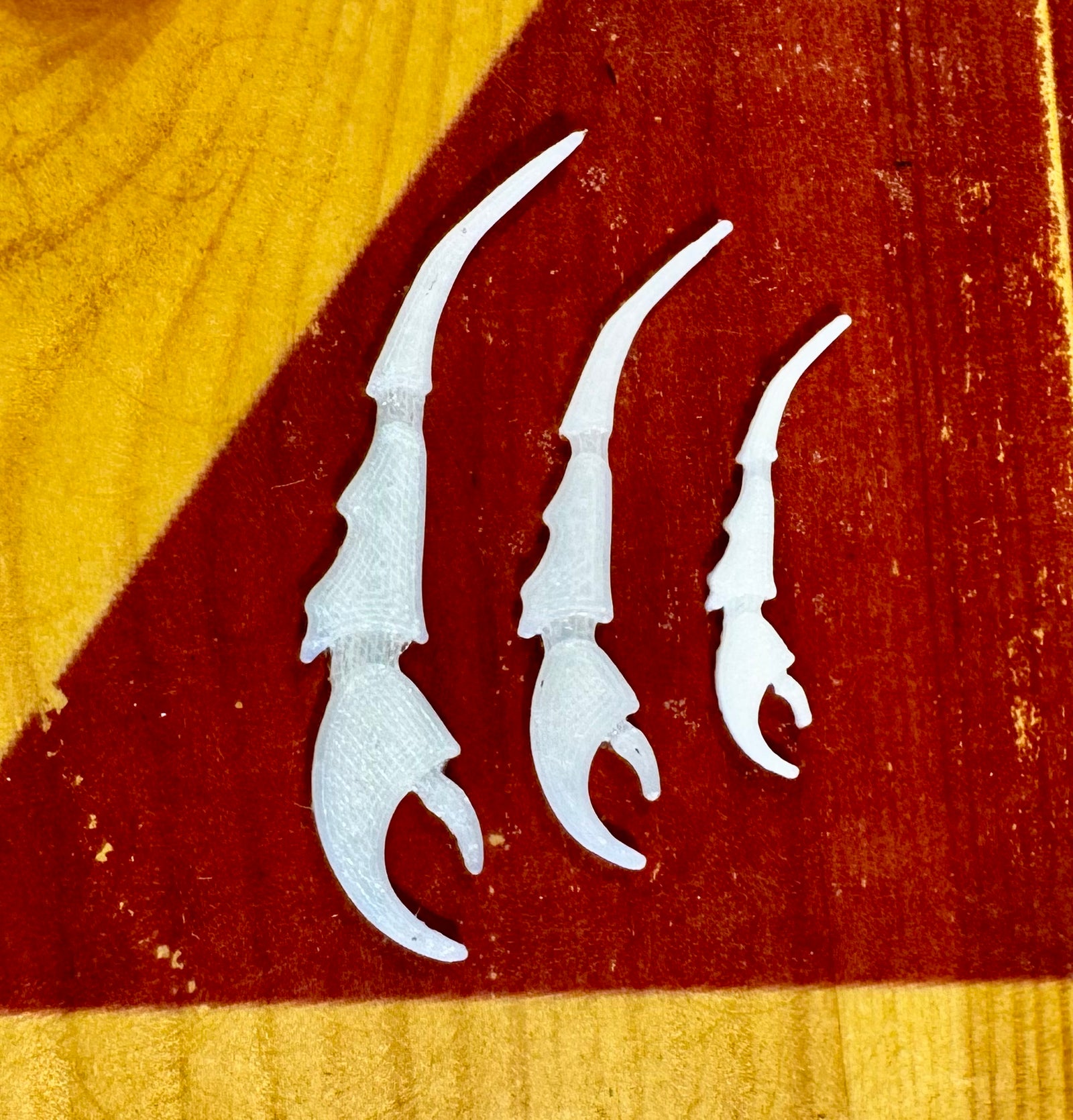 Set of three white 3D printed crab claws for fly tying materials