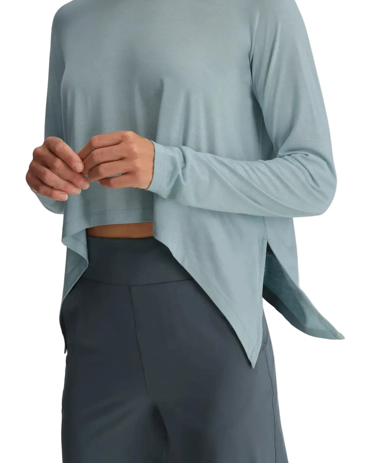 Close-up detail of relaxed drape and high-low hem on Free Fly cropped long sleeve shirt