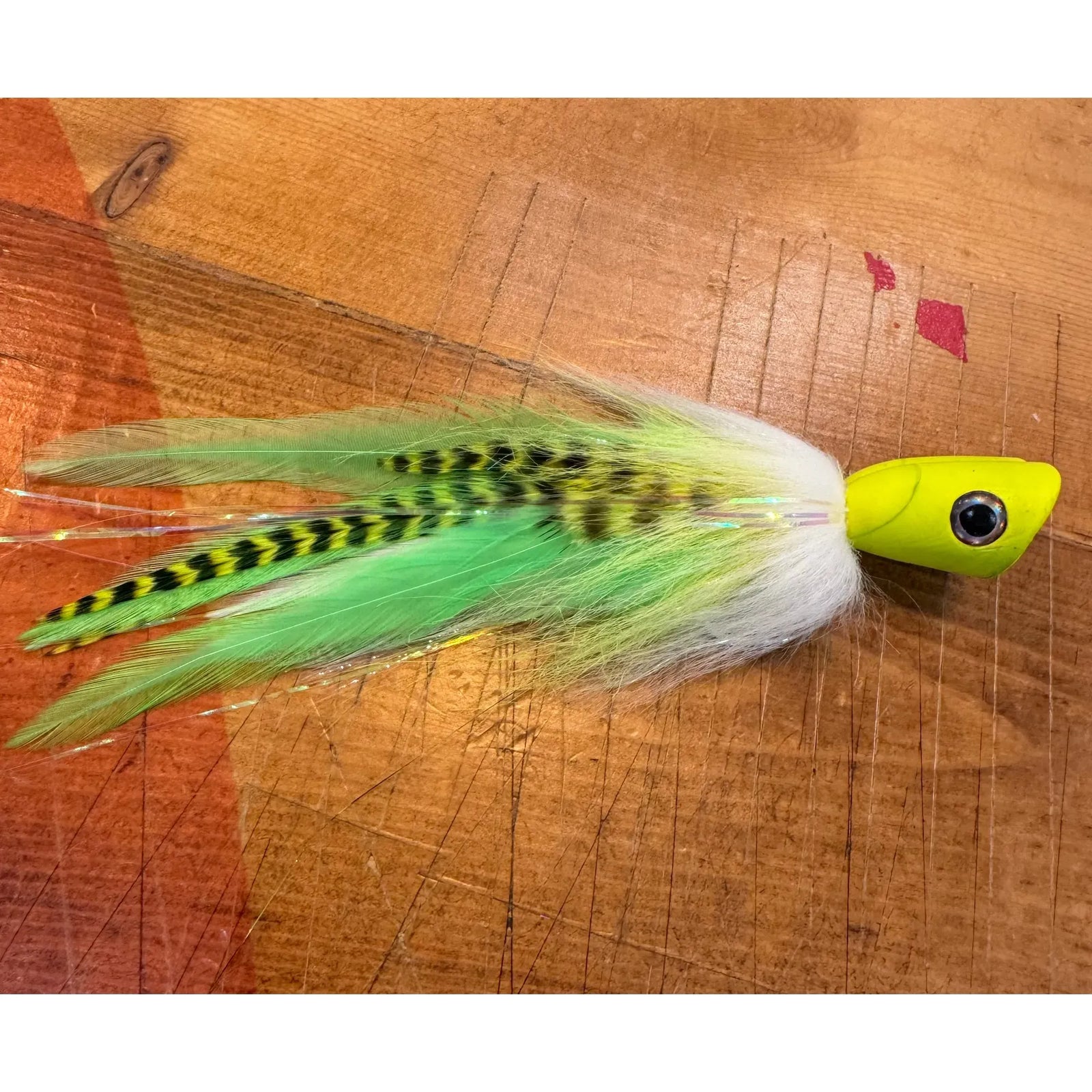 Neon yellow-green peacock bass popper fly with green chevron body
