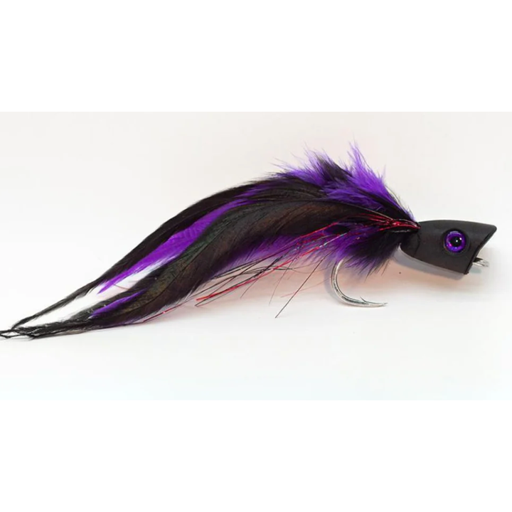 Black topwater popper fly with purple feathers and red tinsel detail