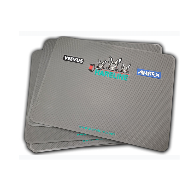 Stack of three gray Hareline Mega Fly Tying Pads showing logos