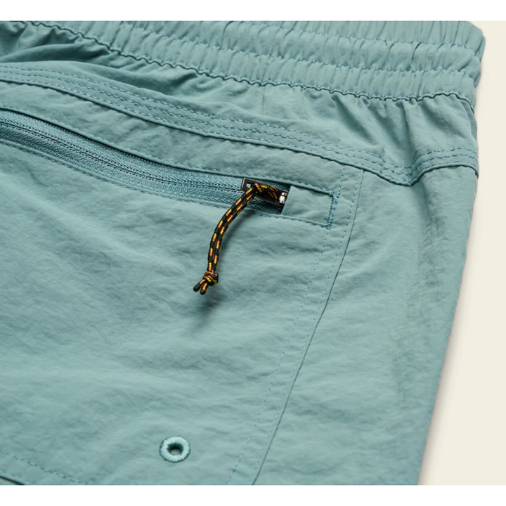 Close-up of drainage grommet and zippered pocket on Howler Bros Salado shorts