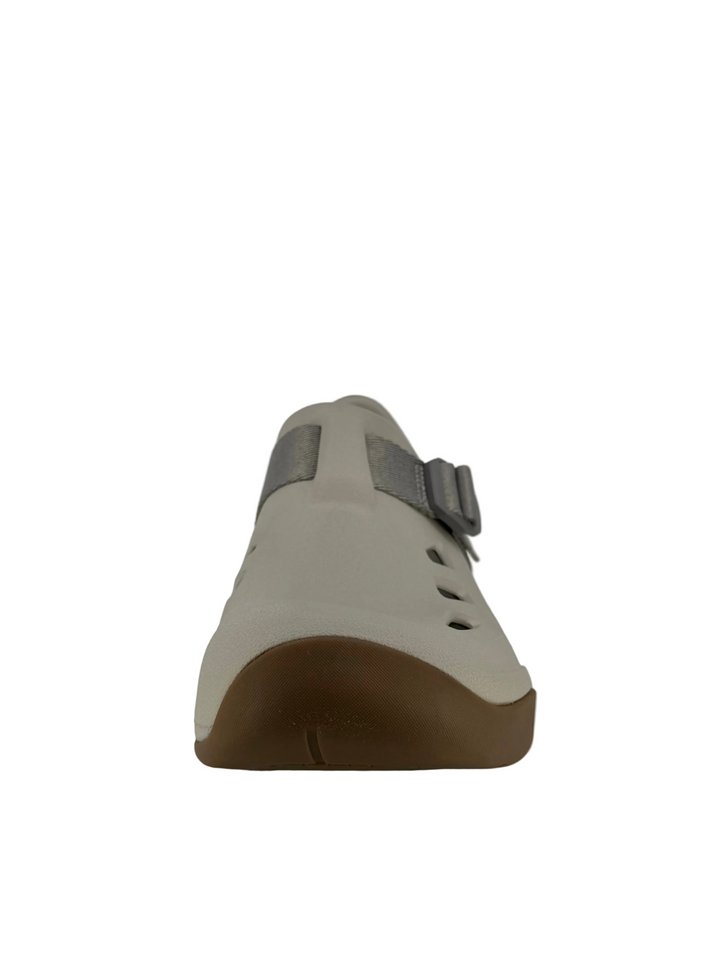 Beige shoe with brown sole on a white background