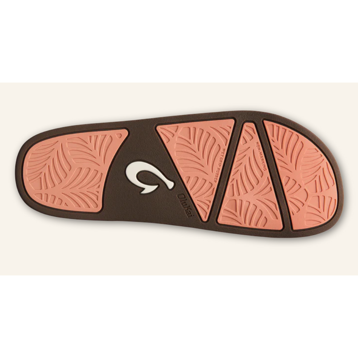 Olukai sandal outsole showing salmon-pink Wet Grip rubber traction pads and fishhook logo