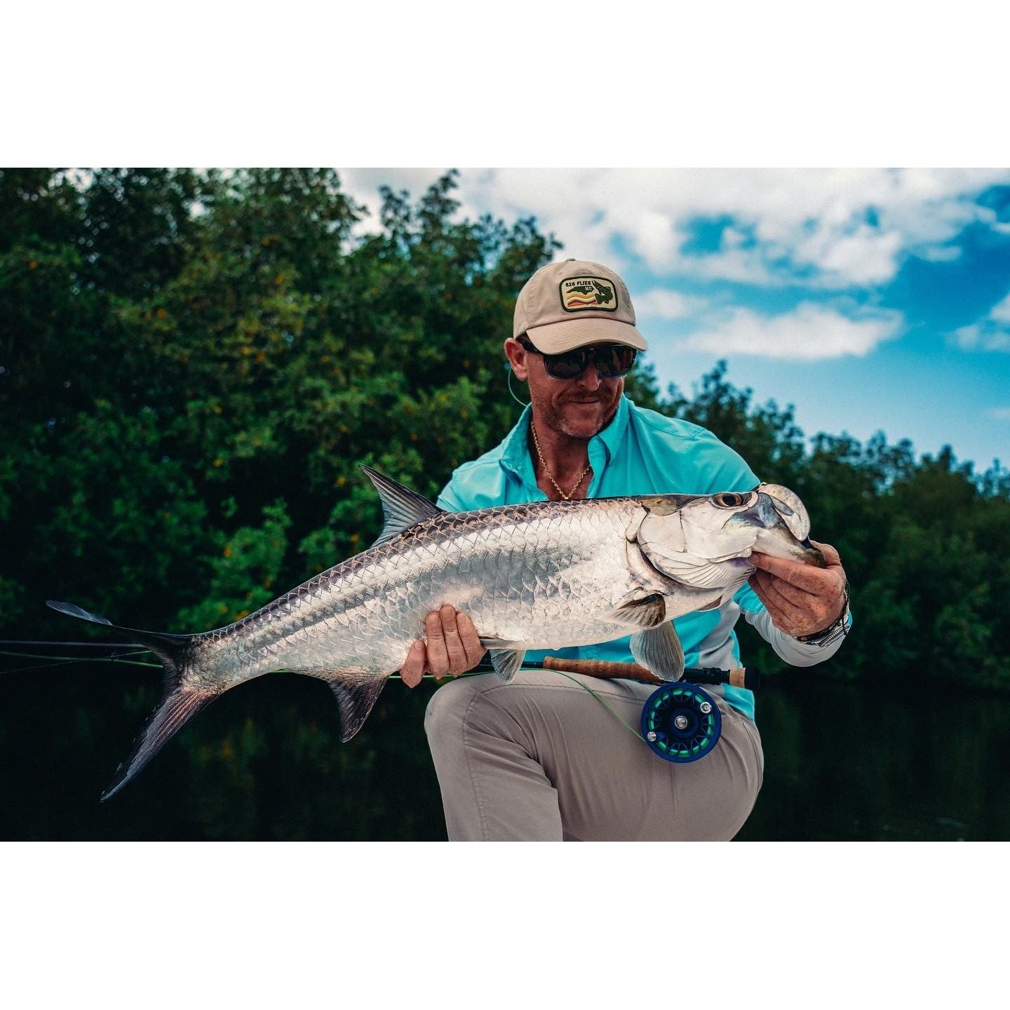 Angler holding juvenile tarpon with Puerto Rico Tarpon Flies rod and reel