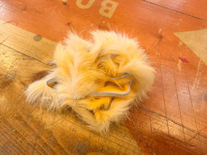Golden yellow fluorescent rabbit fur strip with hide backing