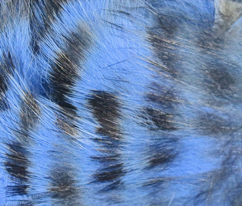 Dyed blue rabbit strip fly tying material with saturated blue fibers and subtle black barring