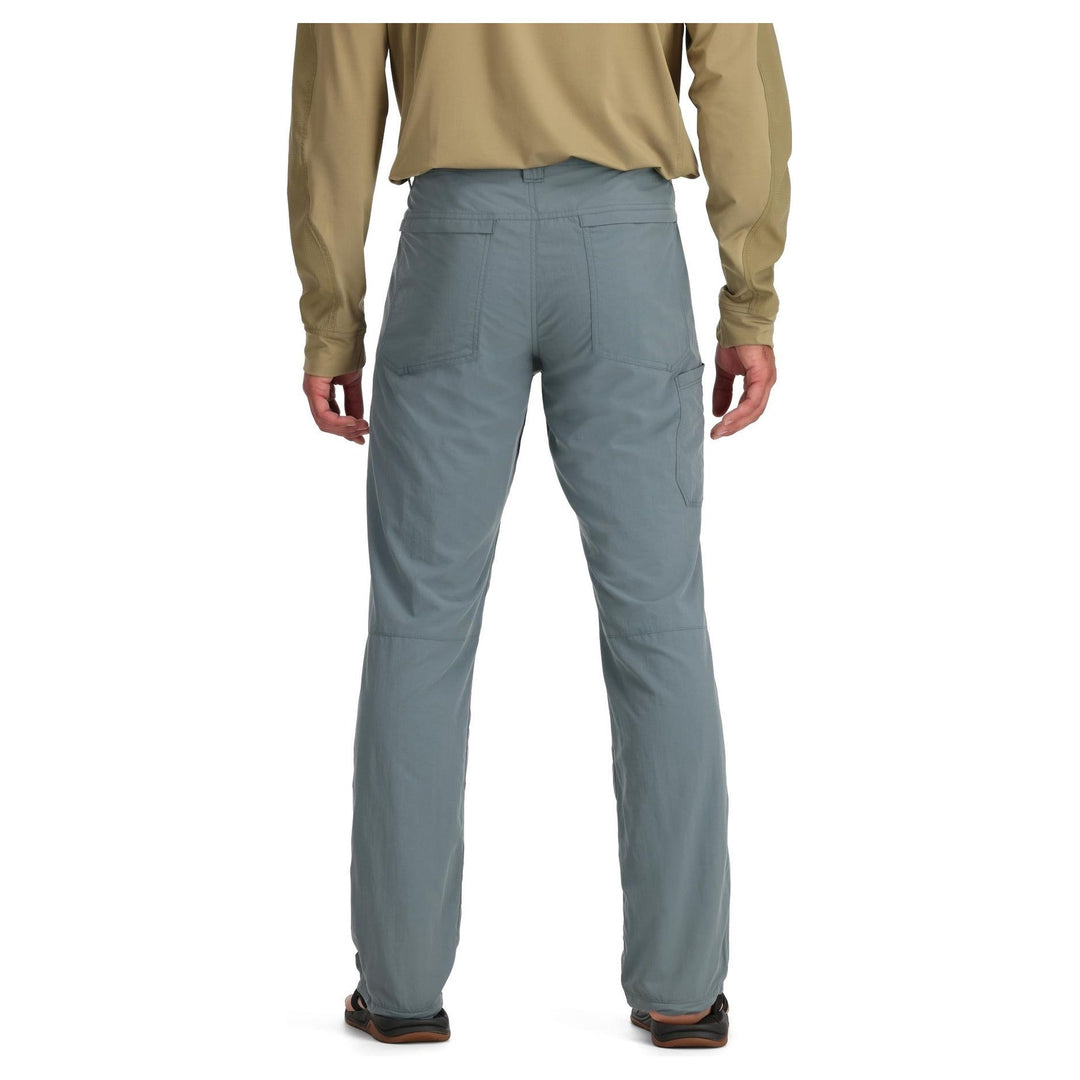 Back view of grey Simms Superlight pants showing zippered back pocket and knee seams