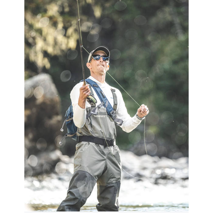 Angler fly fishing in Simms Tributary waders in a river setting