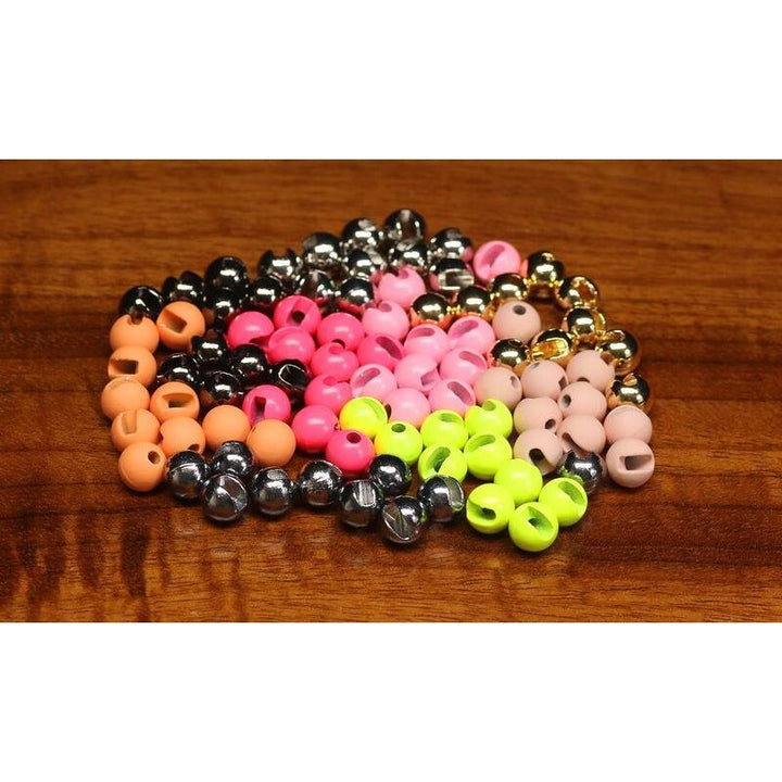 Assorted slotted tungsten beads in silver, gold, pink, and black for fly tying