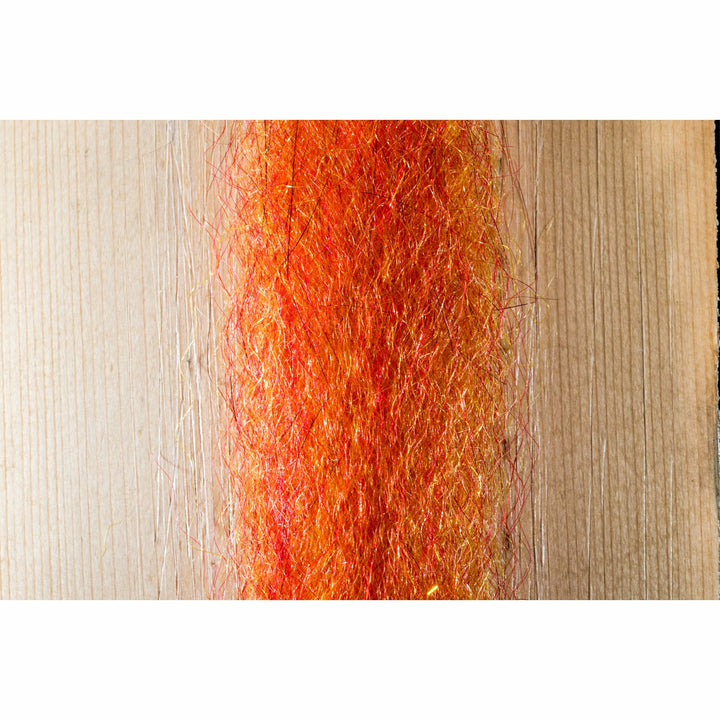 Orange-red vibrant fly tying material mixed with reflective metallic flash strands