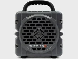Front view of rugged gray Turtle Box Cub portable speaker with circular grille and carrying handle