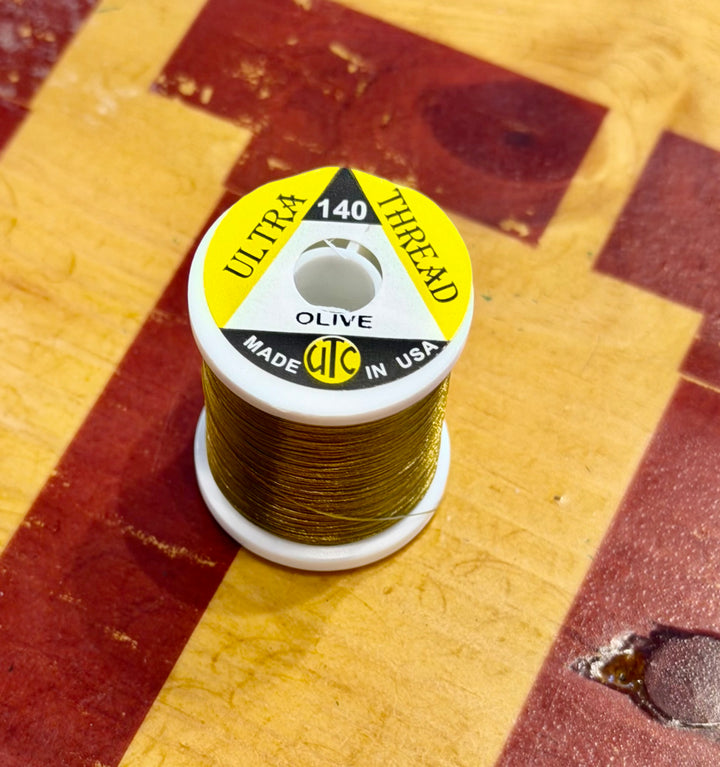 Close-up of Olive UTC Ultra 140 fly tying thread