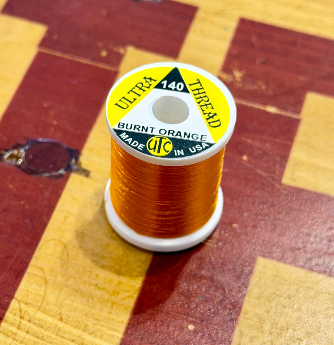 Burnt Orange UTC Ultra 140 thread spool detail