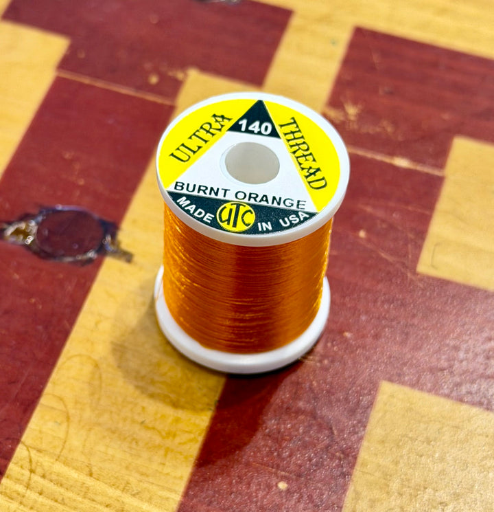 Burnt Orange UTC Ultra 140 thread spool detail
