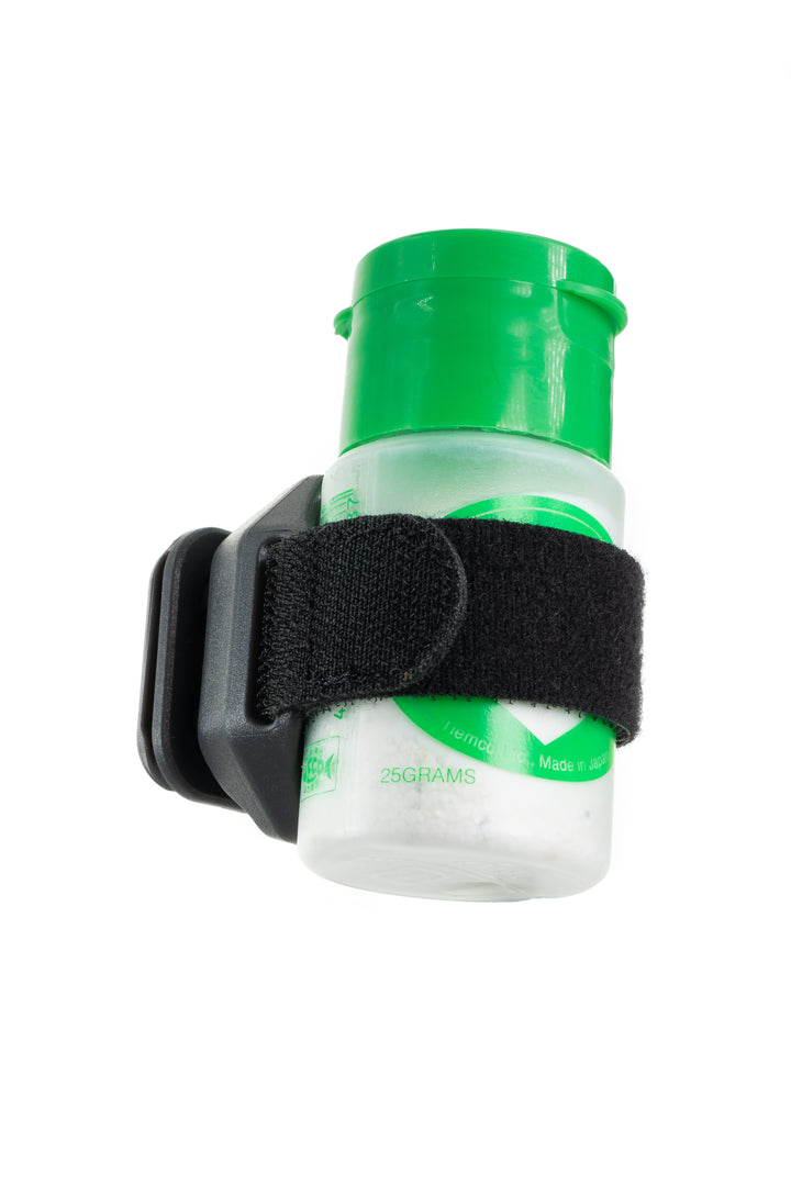 Umpqua LINK DryDock holding clear granular fly floatant bottle with green cap