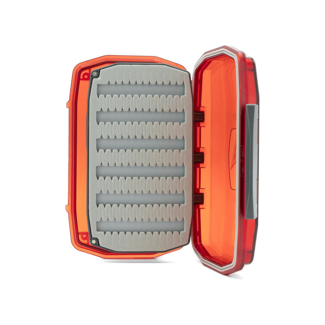 Red waterproof fly box interior detail with scalloped slot foam rows for fly organization