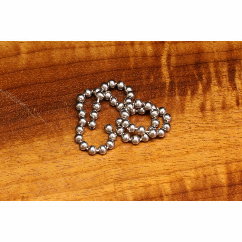 Large silver bead chain for fly tying, coiled on wood