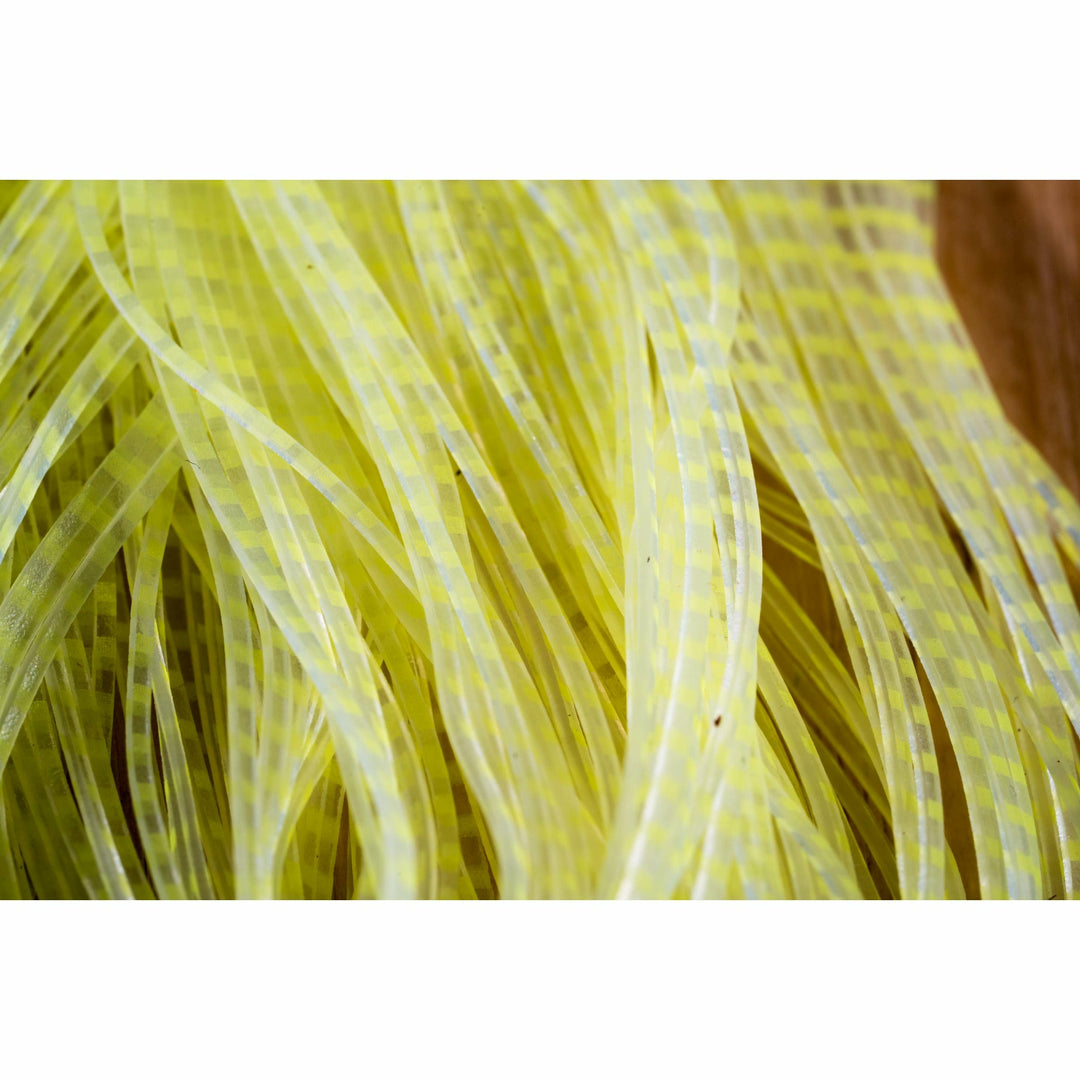 Close-up of fluorescent yellow barred clear plastic fly tying legs