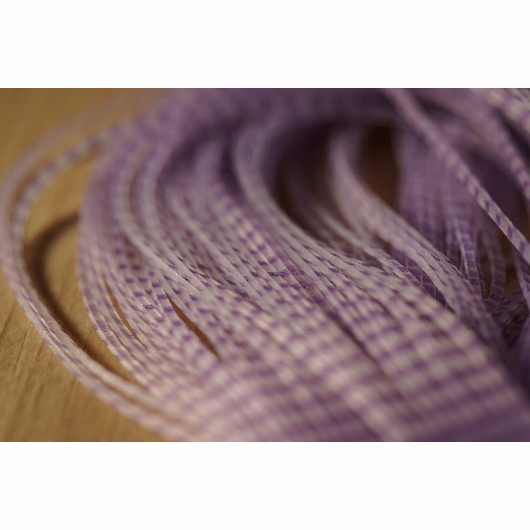 Close-up of translucent purple striped silicone legs for fly tying