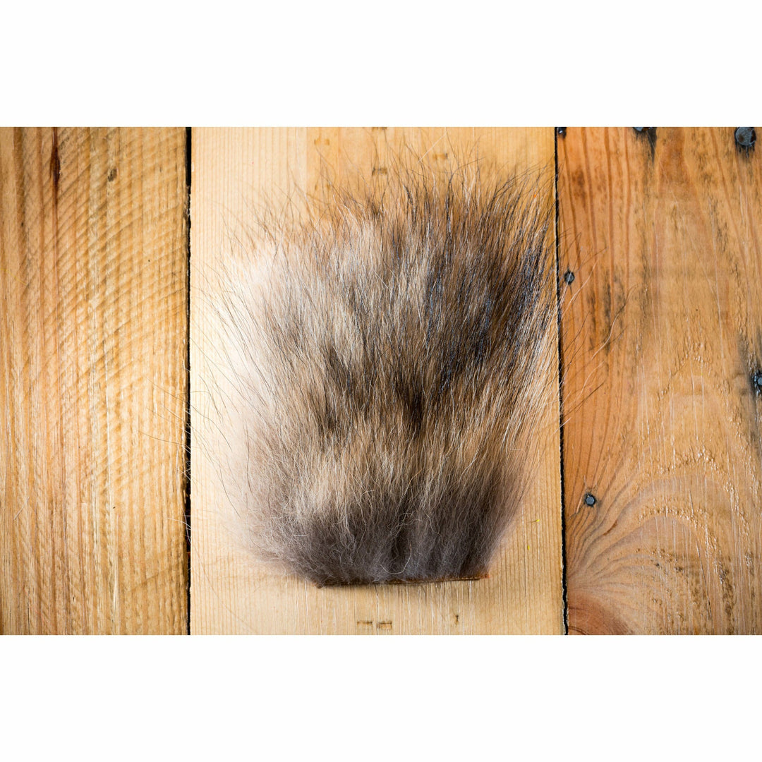 Natural coyote fur fly tying material with grey, tan, and white gradient fibers