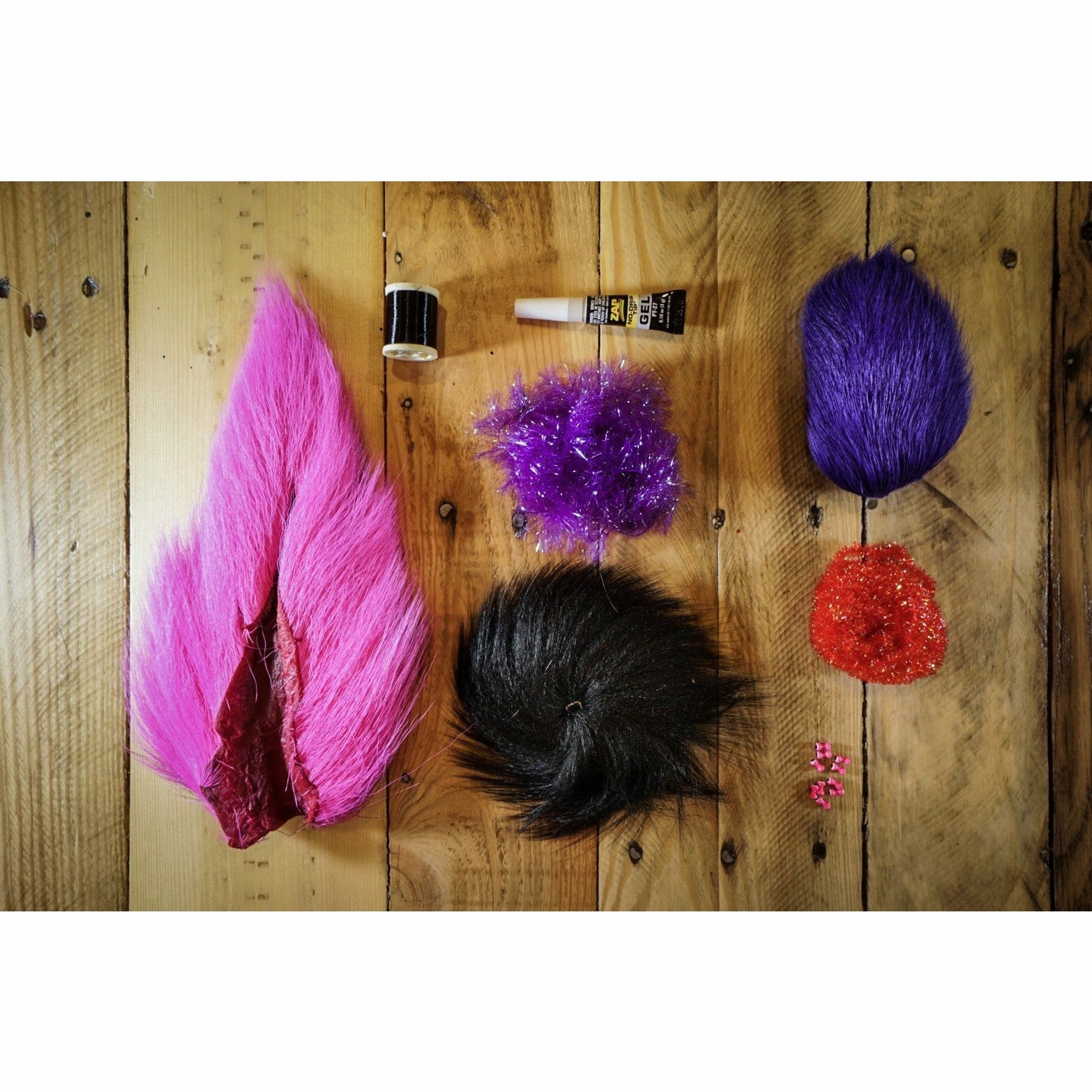 Deer Hair Megalolipop DIY Kit contents: neon grape deer belly hair, purple chenille, fuchsia bucktail, black thread, and eyes