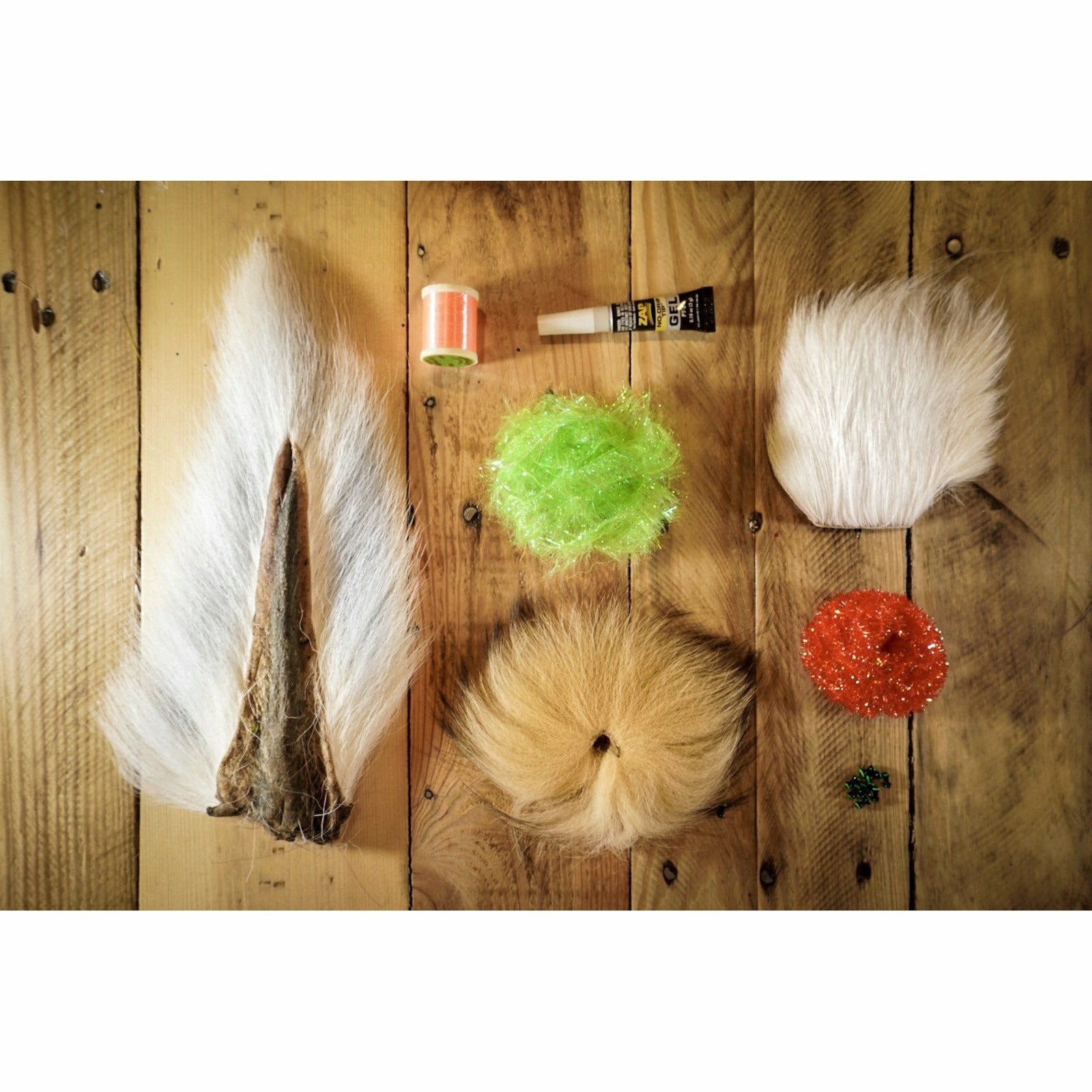 Deer Hair Megalolipop DIY Kit materials flat lay with arctic fox tail, buck hair, chenille, and thread