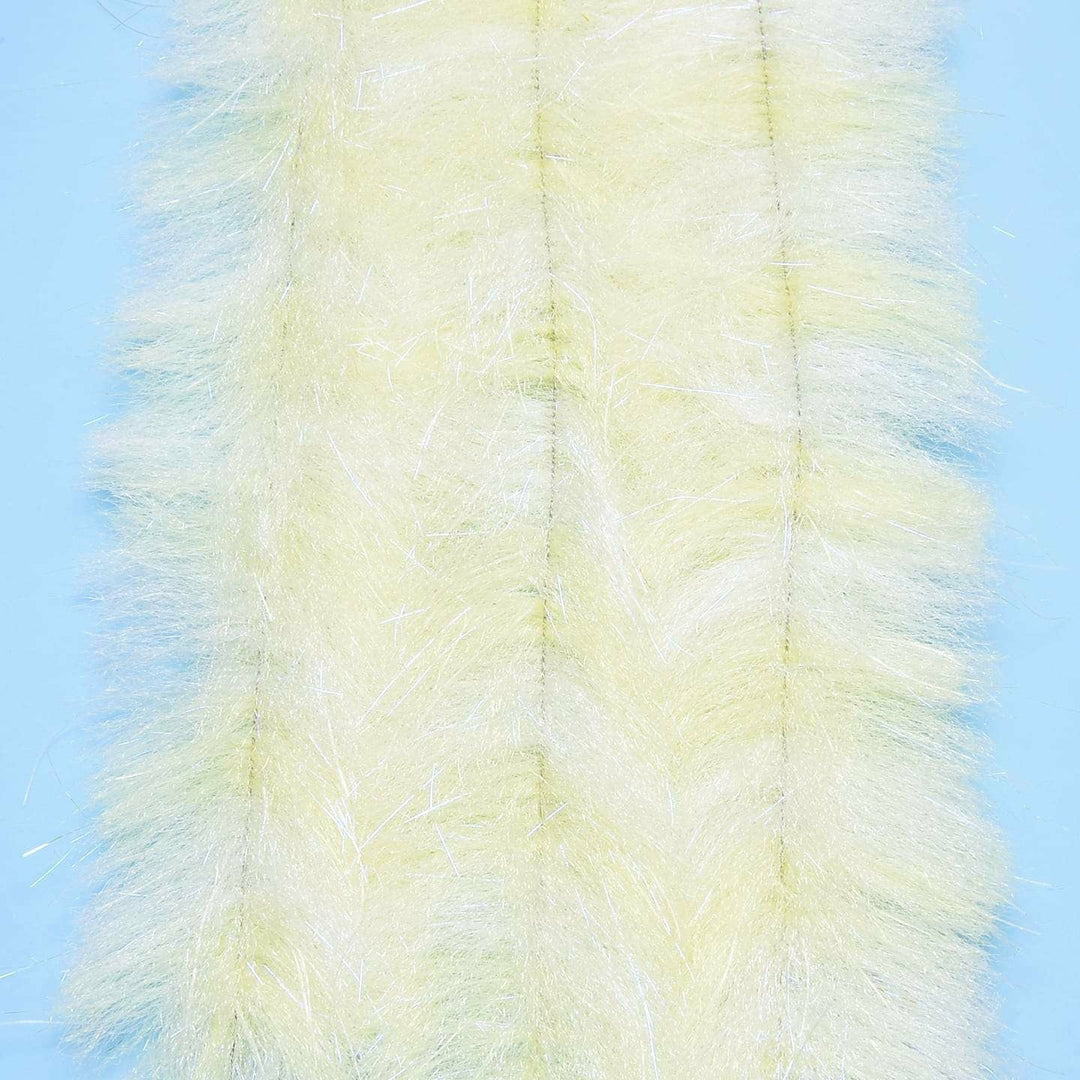 Pale yellow translucent brush with white UV sparkle on light blue background for shimmer