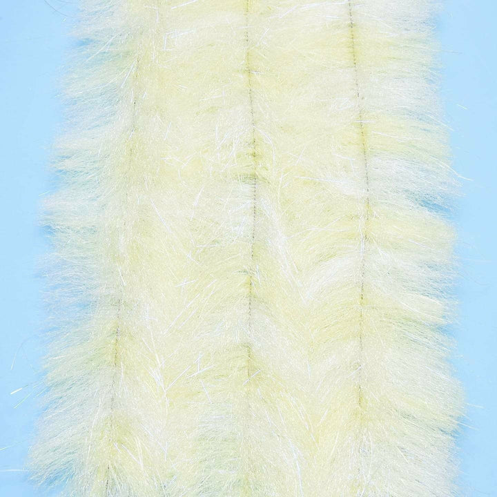 Pale yellow translucent brush with white UV sparkle on light blue background for shimmer