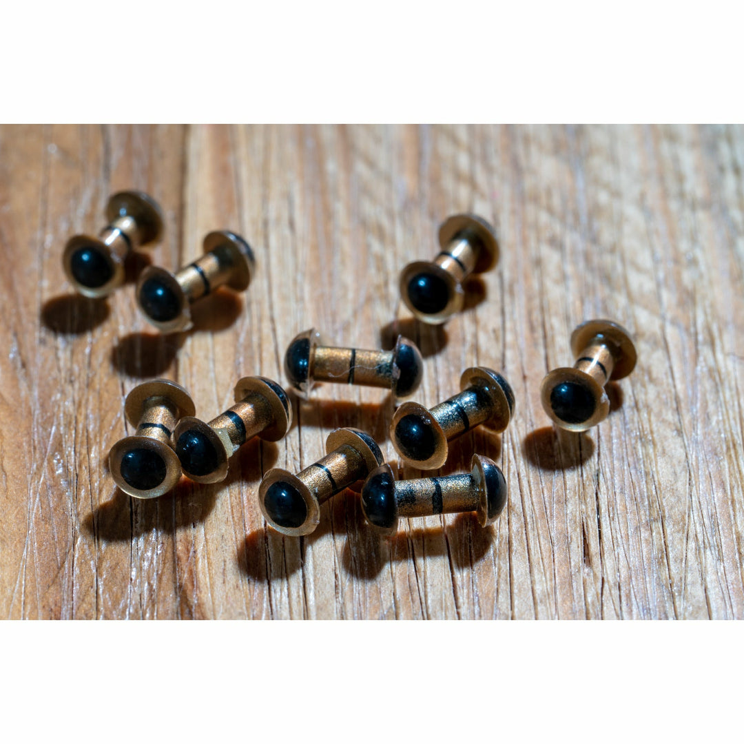 Close-up of matte gold metal construction and glossy black eye lenses