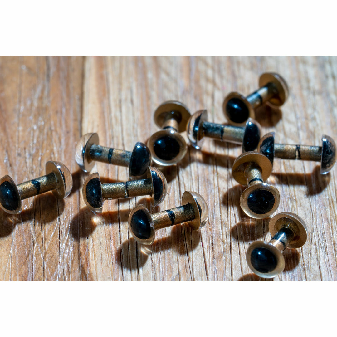 Side view of golden figure-8 fly eyes showing thread wraps and shanks