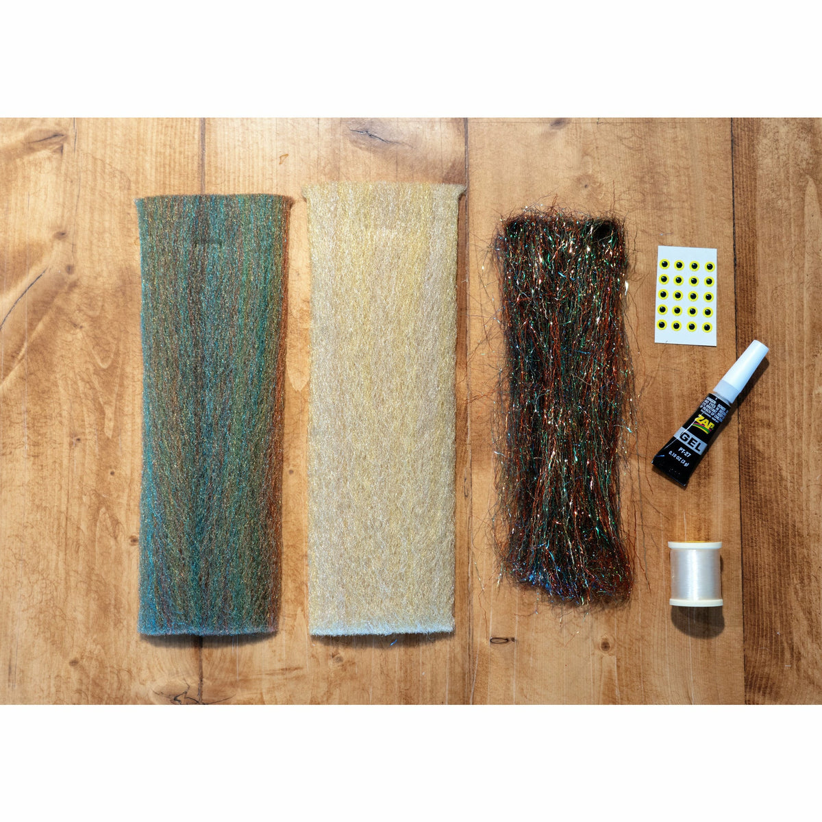 EP Minnow DIY Fly Tying Kit contents: Sand and Back Country 3D fibers, Thunderstruck SPK flash, eye stickers, ZAP A Gel glue, and thread