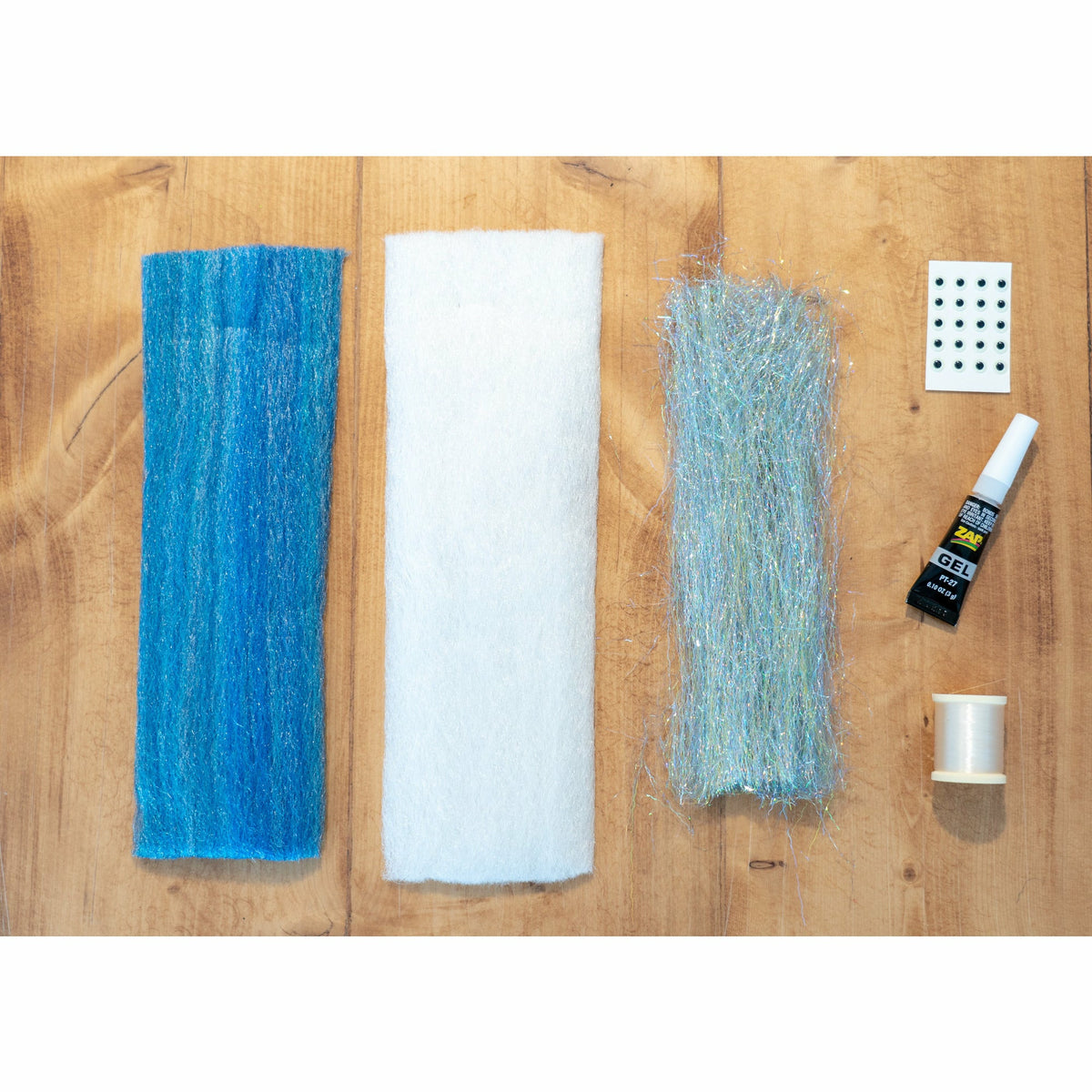 EP Minnow DIY Kit components: Ocean Blue and White EP 3D fibers, silver flash, black eyes, ZAP Gel, and thread
