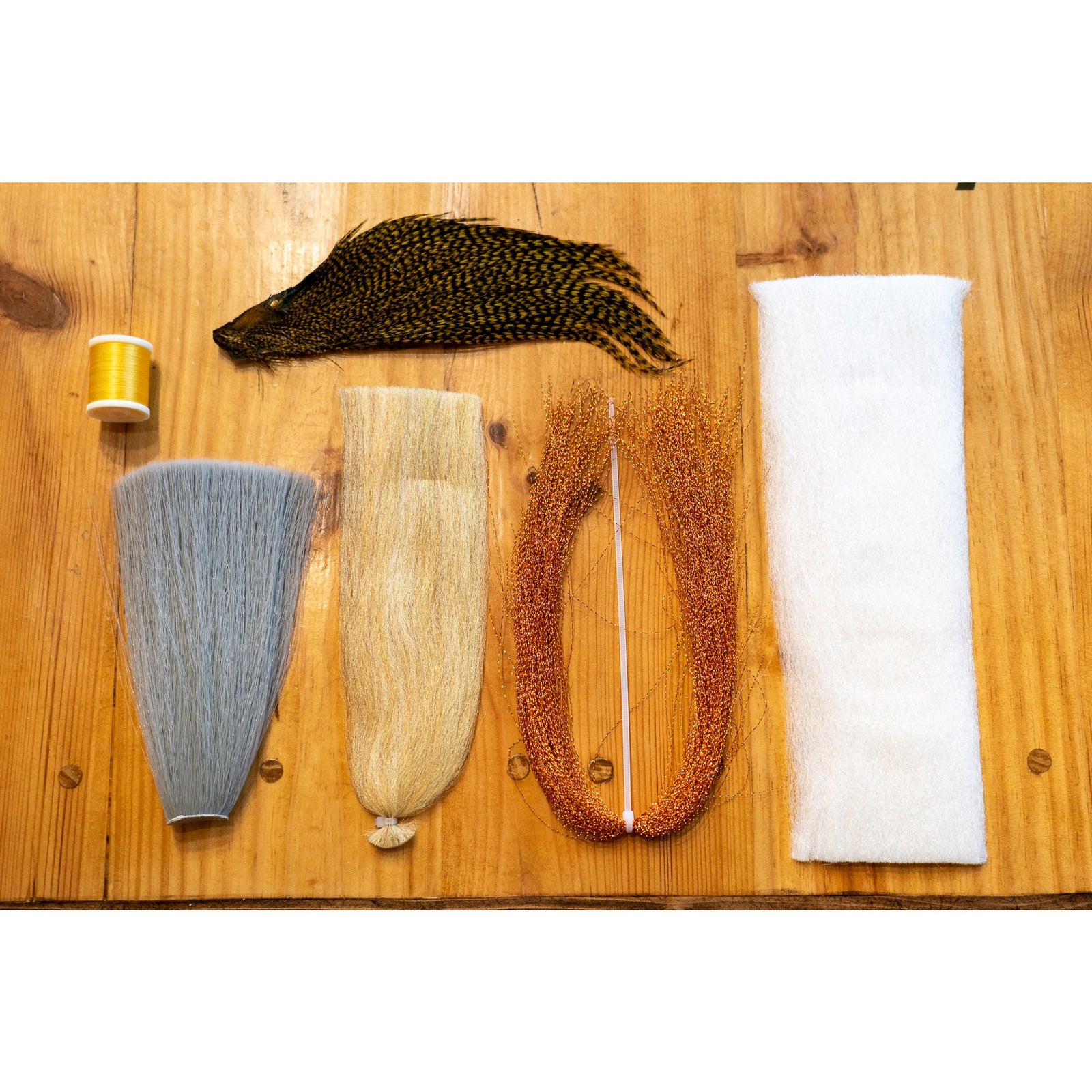 EP Para Dry Fly DIY Kit materials including grey faux bucktail, copper krystal flash, and yellow thread