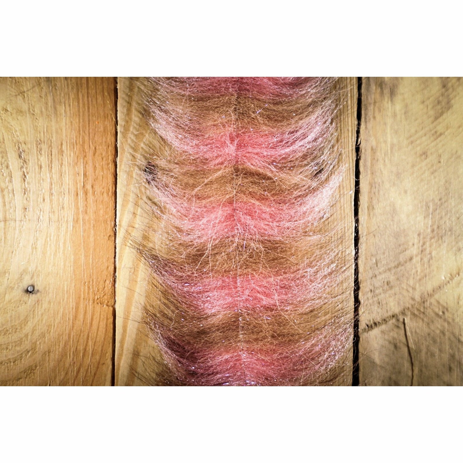 Tan and pink synthetic Grizzley Foxy Brush fly tying material with glitter