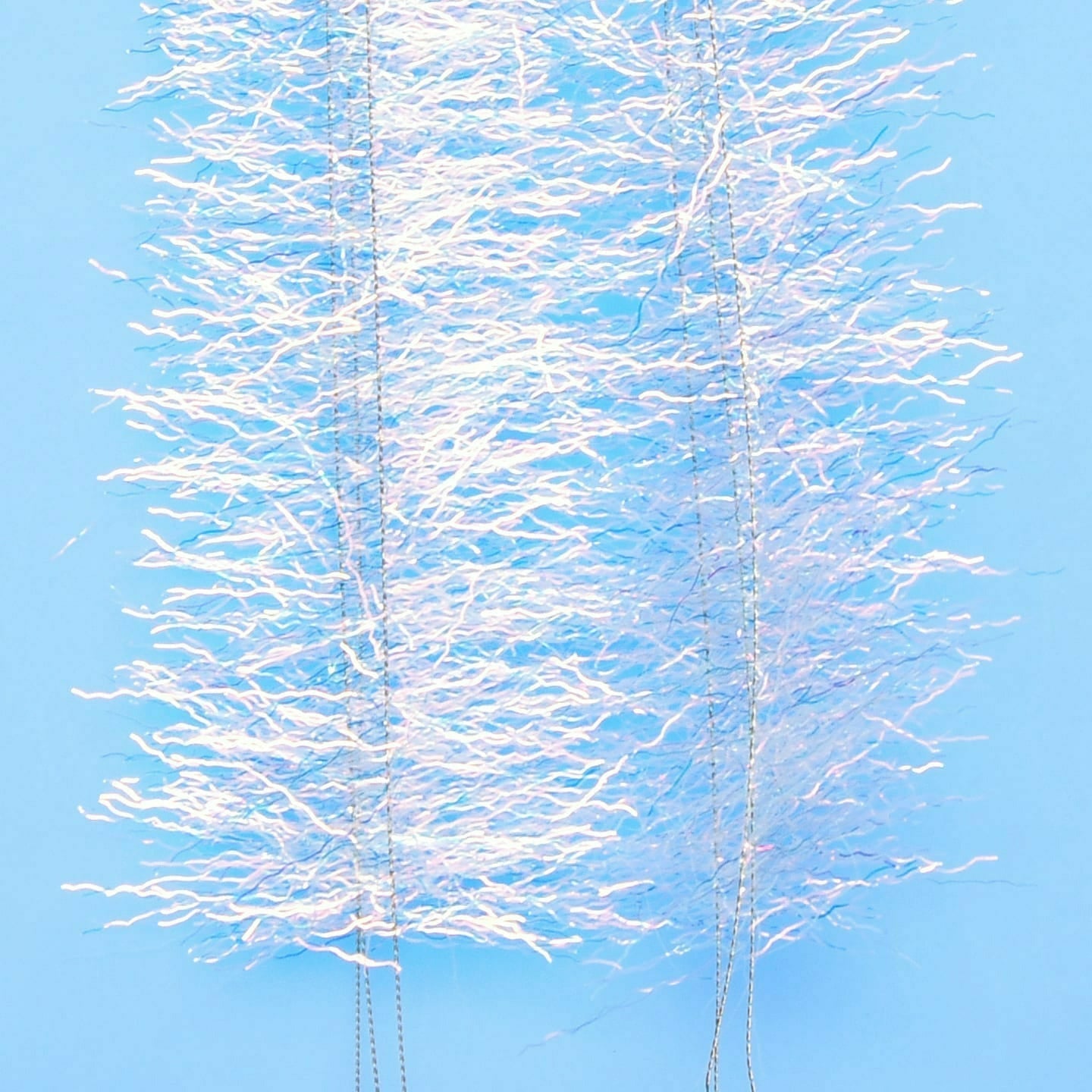 Close-up of crimped iridescent white EP Thunderstruck Brush fibers with stainless steel wire core