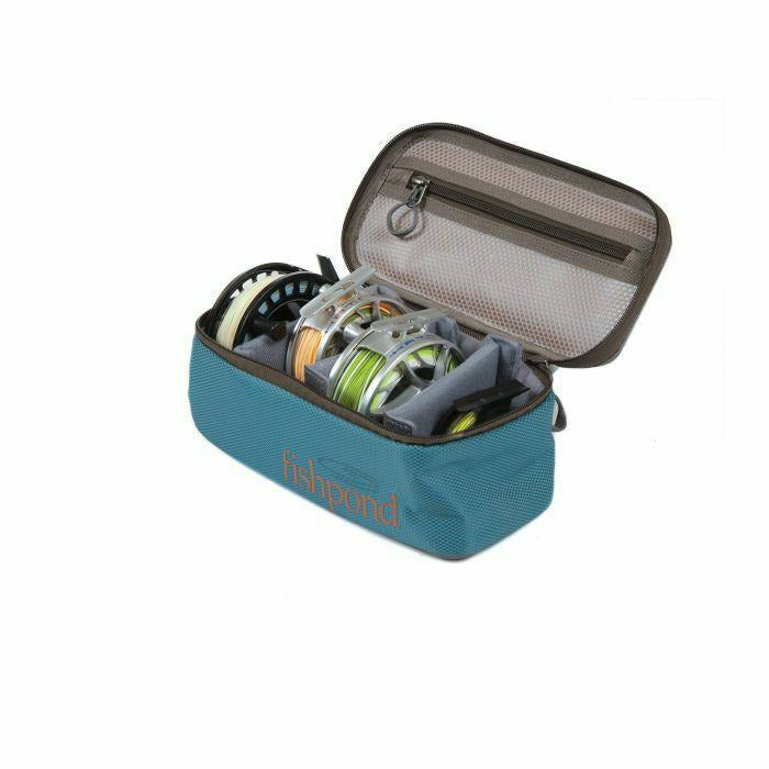 Fishpond Ripple Reel Case in Tidal Blue open with three fly reels secured in padded dividers