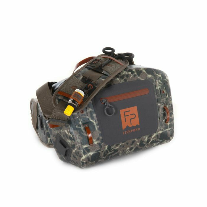 Top view of grey camo Fishpond Thunderhead lumbar with shoulder strap and bottle loop