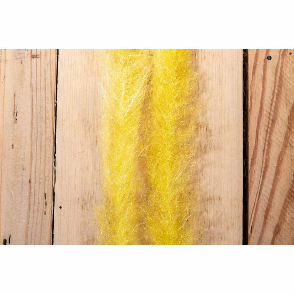 Close-up of bright yellow synthetic fiber dubbin strips for fly tying