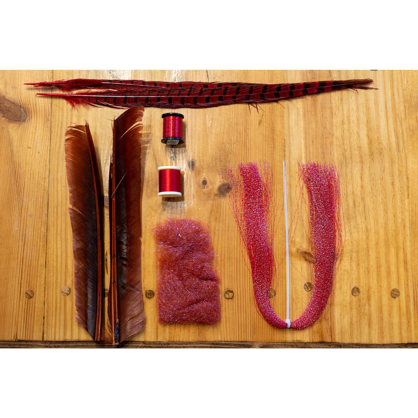 French Quill DIY Kit contents: red ringneck pheasant tail, mahogany turkey biot quills, UV rust ice dub, red krystal flash, and thread spools
