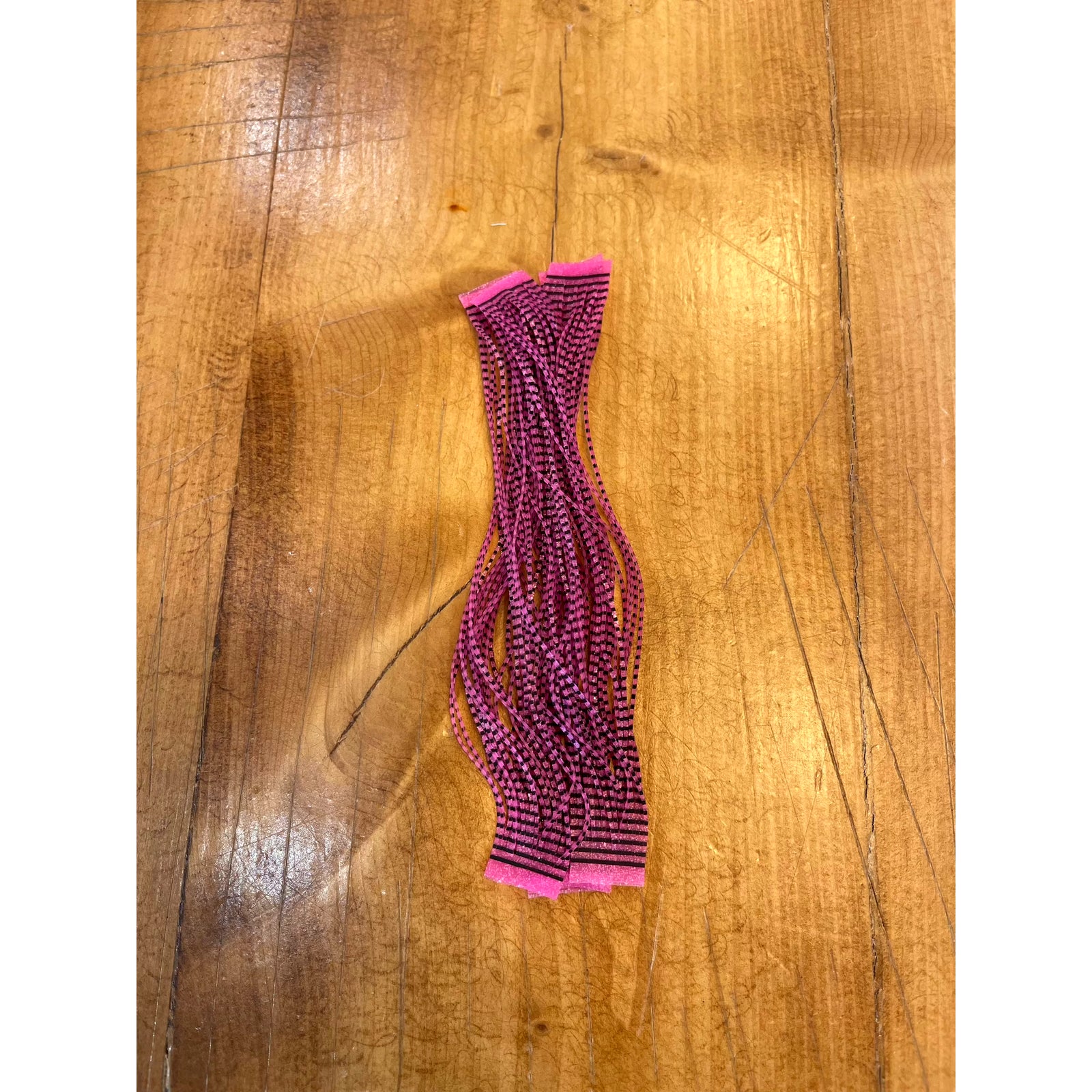 Black Grizzly Flutter Legs with hot pink stripes and tips for fly tying
